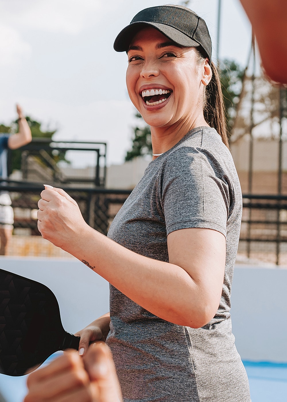 Smiling woman enjoying an outdoor sports activity.