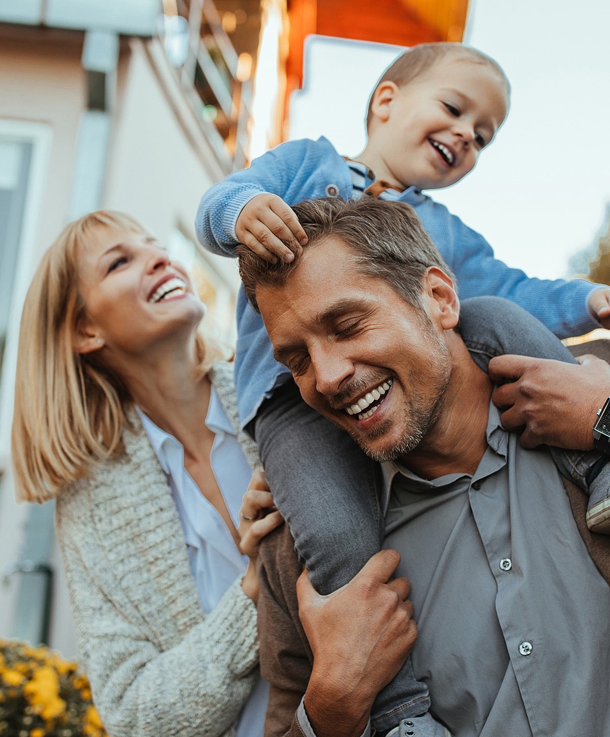 Happy family playing outside together, smiling joyfully.